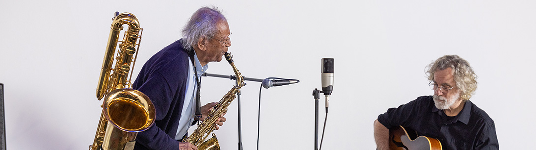 Two musicians playing for an audience.