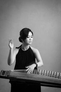 Korean woman playing a gayageum