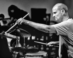 man drumming on stage